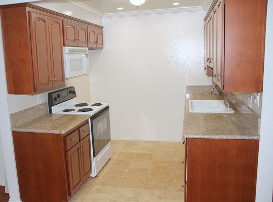 Custom Cheery wood kitchen cabinets, imported granite counters and Travertine Marble Floor