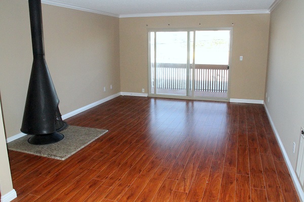 Large Living Room with Hardwood Floor and Fireplace opening to Large Balcony