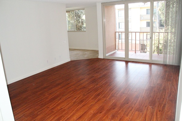 Large Living Room with hardwood floor leading to ocean view balcony  