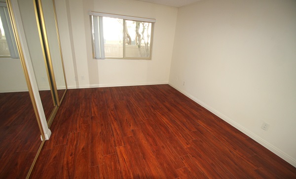 Large Bedroom with mirrored closet doors and hardwood floor