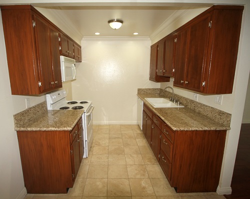 Upgraded kitchen with custom cabinets, imported granite counters and Travertine marble floor