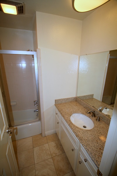 Bathroom with granite counters and Travertine Floor