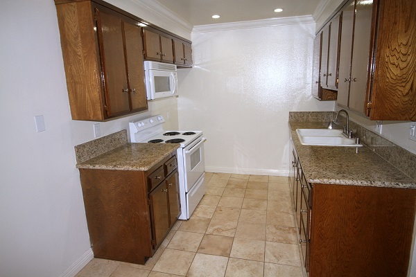 Upgraded kitchen with custom cabinets, imported granite counters and Travertine marble floo