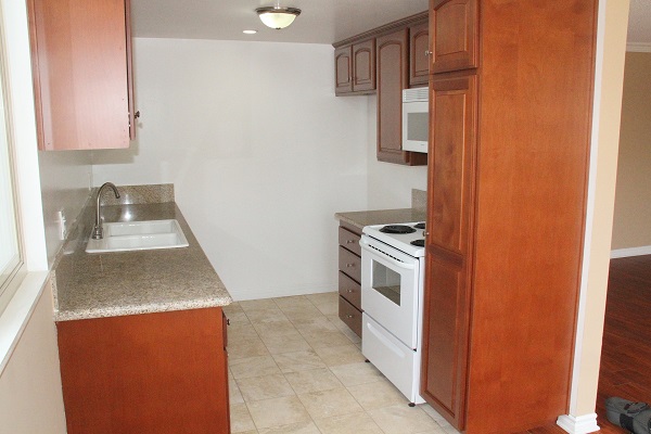 Kitchen with new custom cherry wood cabinets and Travertine floor