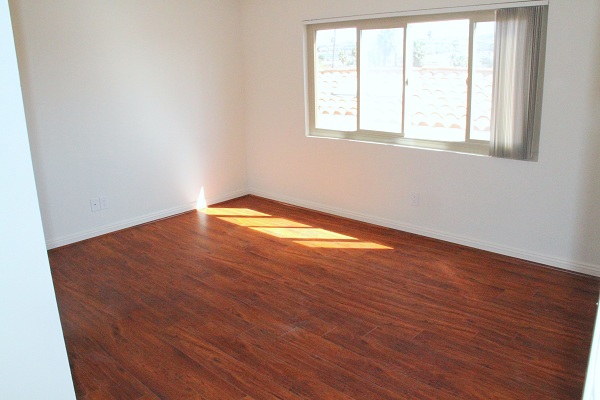 Large Bedroom with Hardwood Floors and Mirrored Closet Doors