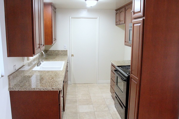 Fully upgraded kitchen with custom cherry wood cabinets, granite and Travertine