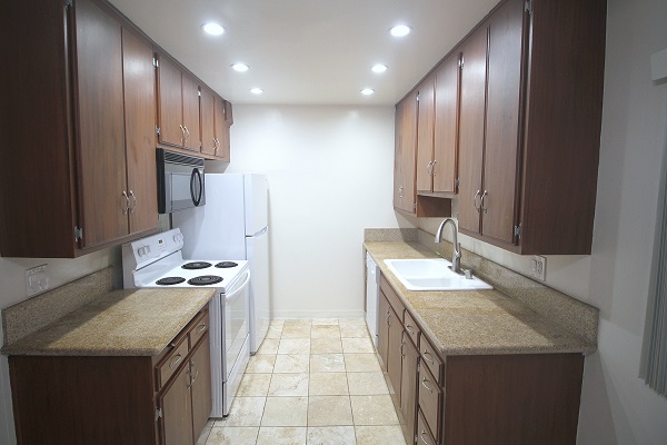 Remodeled kitchen with imported granite counters and Travertine floor